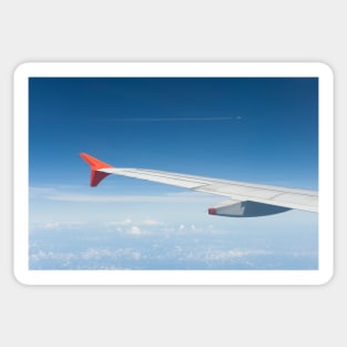 View of an aircraft wingtip with another aircraft visible flying in the distance. Sticker